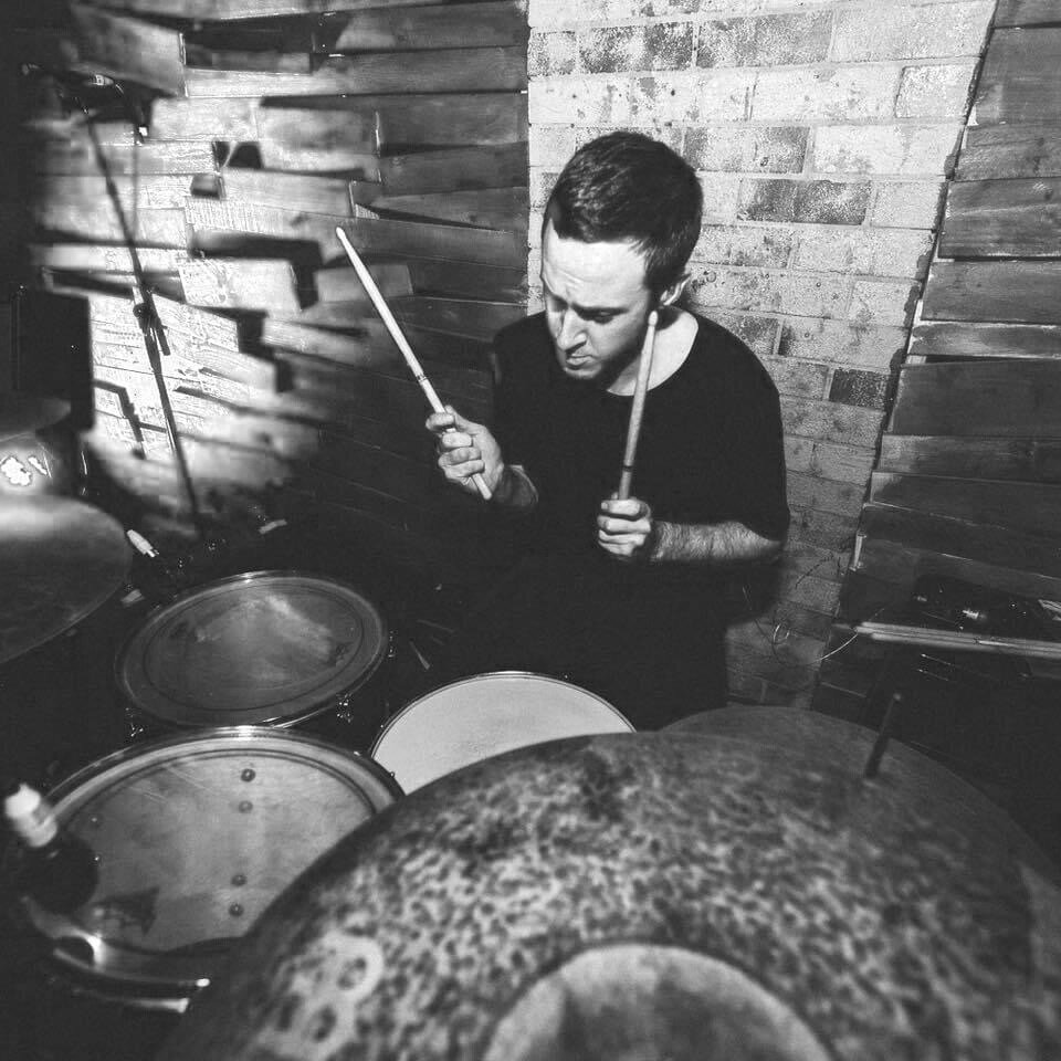 Nathan MacGregor playing drums